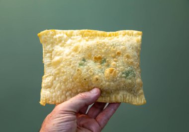 Traditional Brazilian fried pastry stuffed with ground beef. 