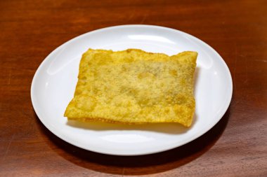 Traditional Brazilian fried pastry stuffed with ground beef. 