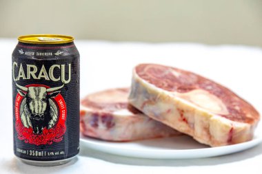 Caracu dark beer with raw beef osso buco clipart