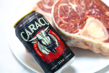 Caracu dark beer with raw beef osso buco clipart