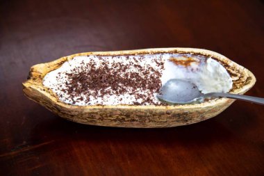 Traditional cupuau cream, cupuau mousse served in the fruit shell with grated chocolate clipart