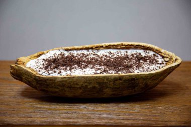 Traditional cupuau cream, cupuau mousse served in the fruit shell with grated chocolate clipart