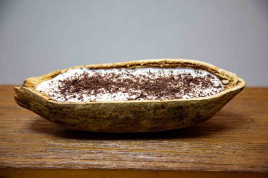 Traditional cupuau cream, cupuau mousse served in the fruit shell with grated chocolate clipart