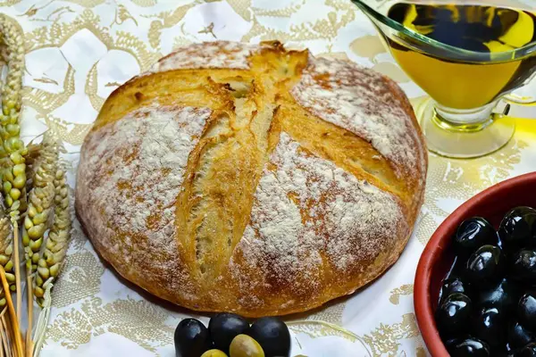 Köy ekmeği, zeytinyağı, şarap, üzüm, tespih ve buğday kulaklı Katolik kutsal masası. İsa 'nın bedeni ve kanı