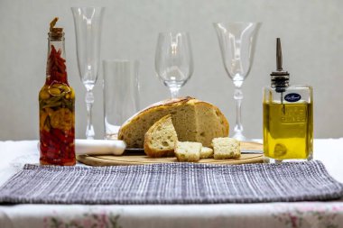 Ekmek, zeytinyağı, peçete ve ev yapımı sıcak soslu köy sofrası. Boşluk. Durgun Hayat