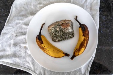 Şımarık, eski küflü yiyecekler beyaz yuvarlak tabakta.