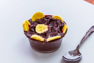 En otantik Brezilya aa 'sı, Euterpe oleracea, minimalist bir kasede muz ve uyumlu bir ortam. Süper gıda enerjisi ve vitaminler