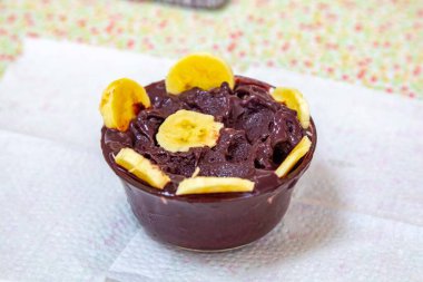 En otantik Brezilya aa 'sı, Euterpe oleracea, minimalist bir kasede muz ve uyumlu bir ortam. Süper gıda enerjisi ve vitaminler