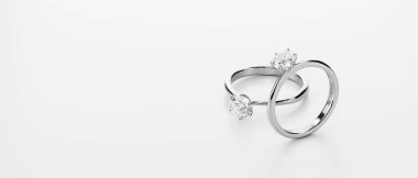 Beyaz arkaplana yerleştirilmiş çift elmas yüzük 3D görüntüleme