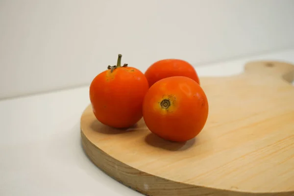 Red tomato vegetables on a wooden stand with close-up shot.