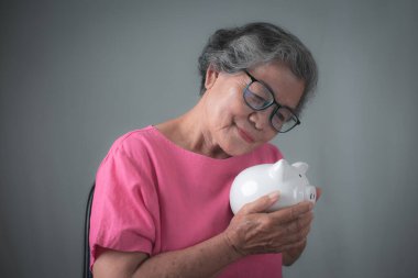 Happy woman holding white piggy bank, future finance and savings concept.