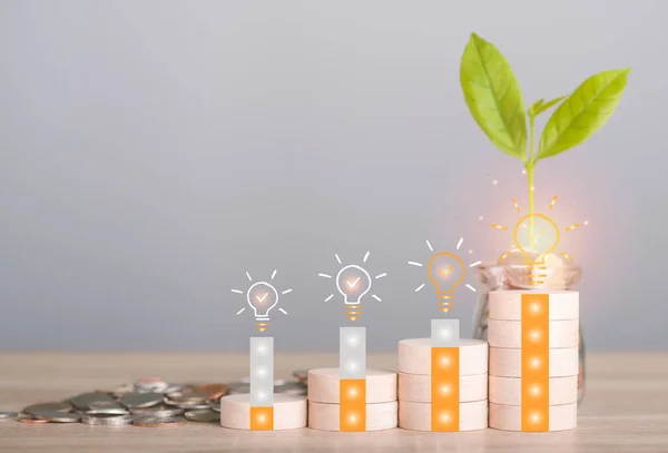 Wooden blocks, stacks of coins and glass jars are all on the wooden table, financial and banking, Fund growth and savings, real estate concept.