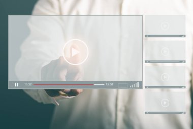 young businessman using virtual monitor to watch video Stream online videos on the Internet, live concerts, shows or tutorials. Virtual screen concept with hands typed on keyboard.