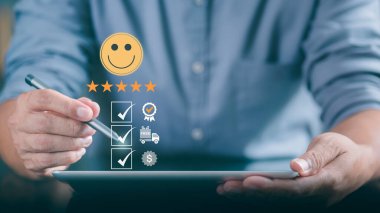 Male consumers use tablets to assess their satisfaction and provide ratings and reviews online. Customer Experience Survey Concepts for Services and Products and customer engagement