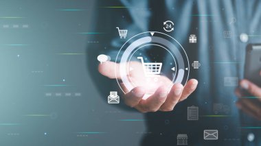 Ecommerce concept and online selling website,Retail business with cyberspace technology used to communicate between store owner and customer.A virtual shopping cart in the hands of a man.