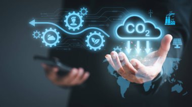 Industrial emissions pollute the environment and ecosystems. including climate change, Carbon Renewable Energy Agreement, reducing greenhouse gas emissions,businessman holding an icon in his hand