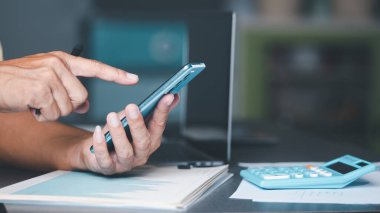 management is checking the information via a smartphone. Concept of handling transactions and documents, and filling out legal forms or agreements, data gathering and statistical working.