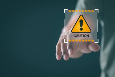 Young man pointing at exclamation mark icon, warning label concept, safety warning sign, maintenance error message, warning system problem should be careful.