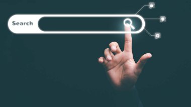 Man's hand pointing at search icon, technology concept researching keywords to find information from online websites, website link discovery and computer communication network, browsing web browser.