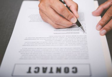 Business owner checking documents and reports and agreements To consider the approval of the business contract, before signing the signature, employment idea, project review, work from home.