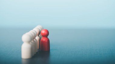 Red wooden dolls placed separately from the row,The concept of human resource management, leadership, recruiting outstanding and best professionals.