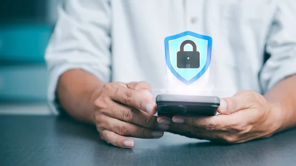 Managing cybersecurity with online authentication technology, young businessmen use their mobile phones to log in with encryption and through the authorization and authentication from the database.