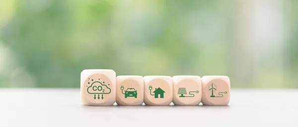 Industrial emissions pollute the environment and ecosystems. including climate change Carbon Renewable Energy Agreement reduce greenhouse gas emissions ,icon and wooden blocks on table