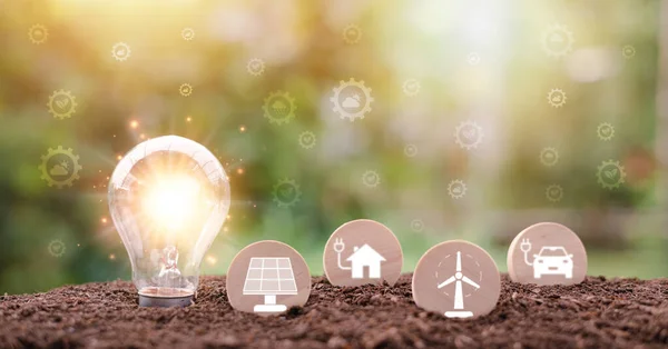protecting the environment alternative energy Sustainable renewable energy sources Green energy innovation and environmentally friendly energy technology,Light bulbs and wooden blocks are in the soil.