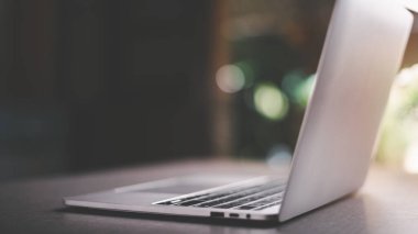 laptop on the table, online work concept Through wireless connection, the work of the new generation of employees through the device.