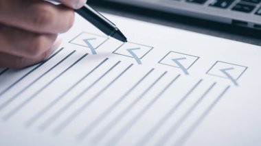 human hand check mark on paper,check concept through checkboxes, surveys through questionnaires, comments to lead Develop and fix bugs,Marking On Checklist