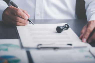Businessman validates and manages business documents and agreements. , signing a business contract approval of contract documents confirmation or warranty certificate,employment idea, project review