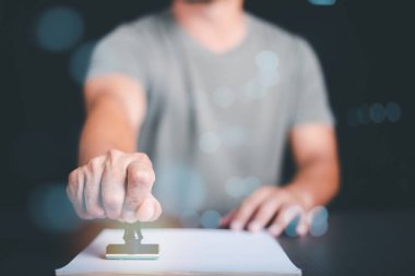 Businessman validates and manages business documents and agreements, signing a business contract approval of contract documents confirmation or warranty certificate,approval stamp