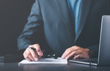 Businessman validates and manages business documents and agreements, signing a business contract approval of contract documents confirmation or warranty certificate,approval stamp