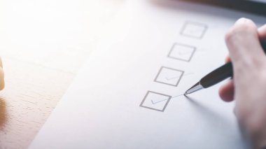 human hand check mark on paper,check concept through checkboxes, surveys through questionnaires, comments to lead Develop and fix bugs,Marking On Checklist