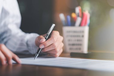 Businessman validates and manages business documents and agreements, signing a business contract approval of contract documents confirmation or warranty certificate,employment idea, project review