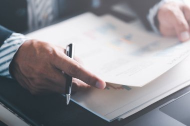 Business people read business statistics chart reports, to analyze and improve corporate strategy, manage financial and marketing documents, update annual budget accounts, company growth