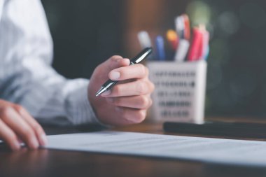 Businessman validates and manages business documents and agreements, signing a business contract approval of contract documents confirmation or warranty certificate,employment idea, project review