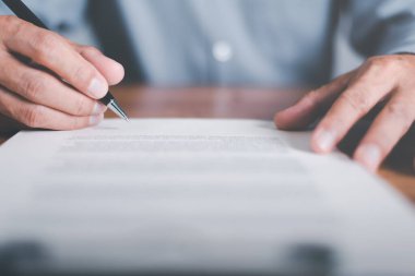 Businessman validates and manages business documents and agreements. , signing a business contract approval of contract documents confirmation or warranty certificate,employment idea, project review