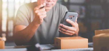 Startup or small business entrepreneur,Expressing joy from sales growth,order management in online stores, shopping on the internet,Selling online on the Internet,SME,shipping boxes,e-commerce