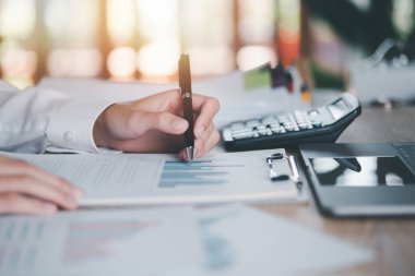 Business people read business statistics chart reports, to analyze and improve corporate strategy, manage financial and marketing documents, update annual budget accounts, company growth data.	