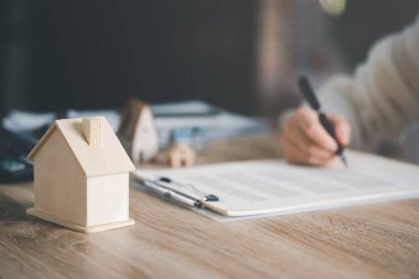 real estate agents and model homes, signing contracts,Investment loan approval concepts for building residential homes, real estate business, investment savings, mortgages and bank loans.