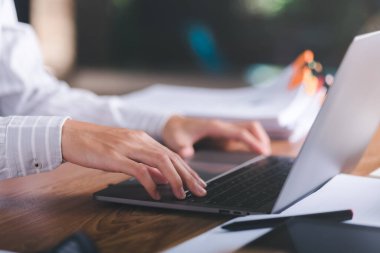 business people use laptops working through an online network,to analyze and improve corporate strategies Manage financial and marketing documents company growth information data management