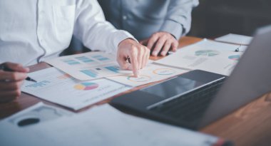 Business people read business statistics chart reports, to analyze and improve corporate strategy, manage financial and marketing documents, update annual budget accounts, company growth data.