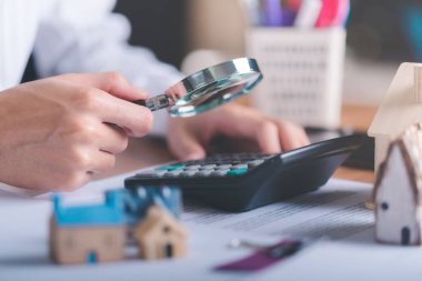man holding magnifying glass,concept of a loan for housing,Approval of credit for the purchase of real estate,business and finance concept,home loan refinancing,Residential sale and mortgage planning