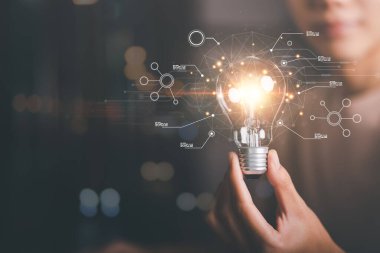 solution concept and demonstrating leadership strategies,that lead the business in a successful direction,with innovation and brain power from brainstorming,light bulb in human hand