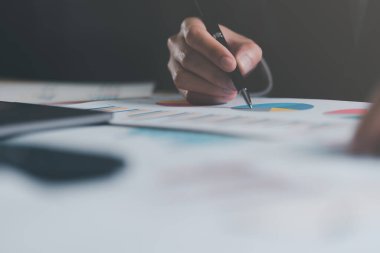 management financial and marketing documents, update annual budget accounts, company growth data,Business people read business statistics chart reports, to analyze and improve corporate strategy