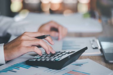 Business people read business statistics chart reports, to analyze and improve corporate strategy, manage financial and marketing documents, update annual budget accounts, company growth data.	