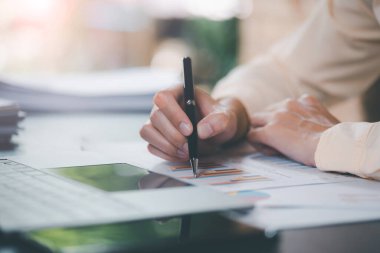 Business people read business statistics chart reports, to analyze and improve corporate strategy, manage financial and marketing documents, update annual budget accounts, company growth data.	