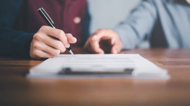 Businessman pointing and signing a business agreement,concept progress in development, financial efficiency and investment with business strategy for goals and opportunities in industry future 