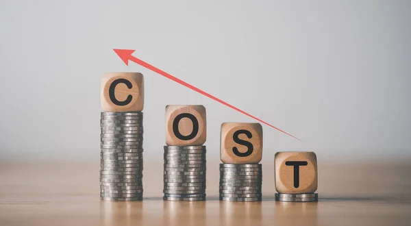 Wooden blocks on pile of coins,Consistently Higher Inflation Concept,financial crisis affecting people all over the world,Currency problems that affect costs and prices of products